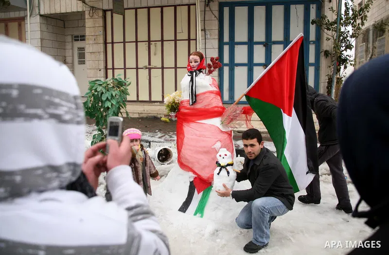 Palestinians build a snowman in the West Bank city of Hebron, on 02 March 2012. A rare snow storm has hit the higher elevations in Israel and the West Bank, including Jerusalem, after four days of pouring rain and high w...