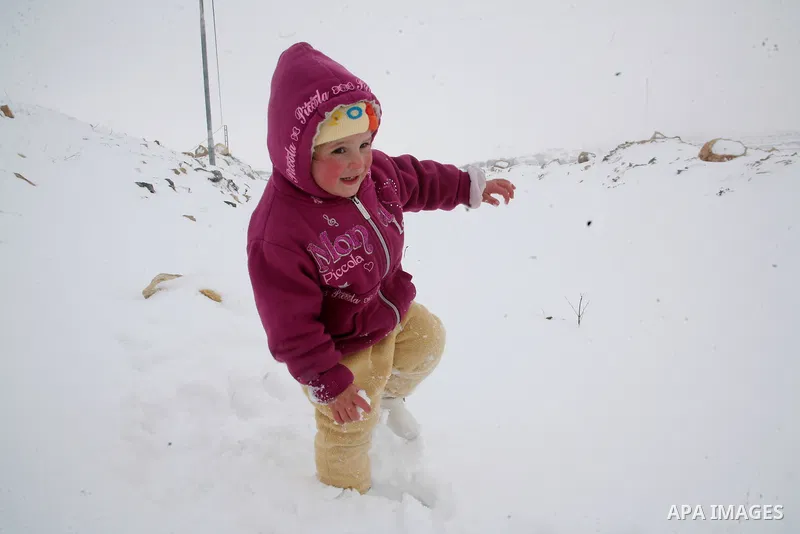 Palestinian girls play with snow in the West Bank city of Hebron as wintry weather swept through the region on March 2, 2012. Photo by Mamoun Wazwaz