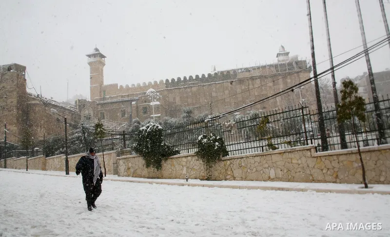 Palestinian man walk outside the site known to Muslims as the Ibrahimi Mosque and to Jews as the Tomb of the Patriarchs in the West Bank city of Hebron, Friday, March 2, 2012. Israelis and Palestinians have woken up to a...
