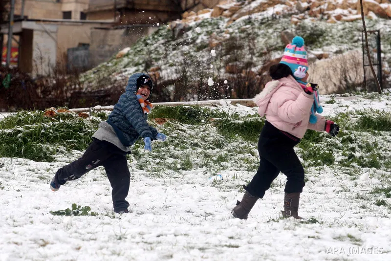 Palestinians throw snowballs in the West Bank city of Ramallah as wintry weather swept through the region on March 2, 2012. Photo by Issam Rimawi