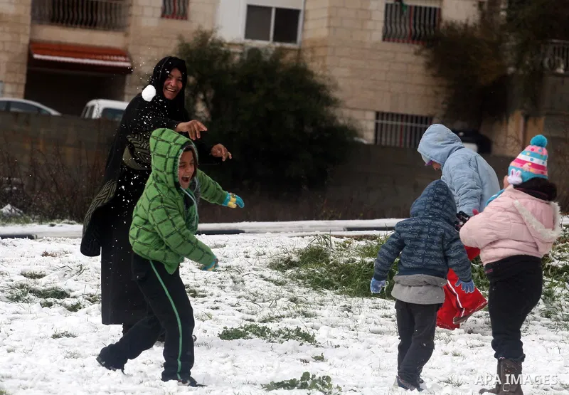 Palestinians throw snowballs in the West Bank city of Ramallah as wintry weather swept through the region on March 2, 2012. Photo by Issam Rimawi