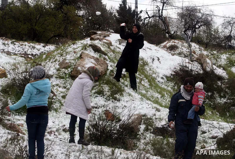 Palestinians throw snowballs in the West Bank city of Ramallah as wintry weather swept through the region on March 2, 2012. Photo by Issam Rimawi