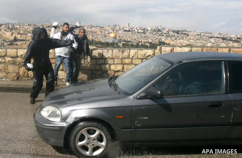 Palestinian youths play with snow in Jerusalem March 2, 2012. Snow fell in Jerusalem on Friday morning. Local media reported this was the first time in four years that snow had fell in Jerusalem causing schools to close...