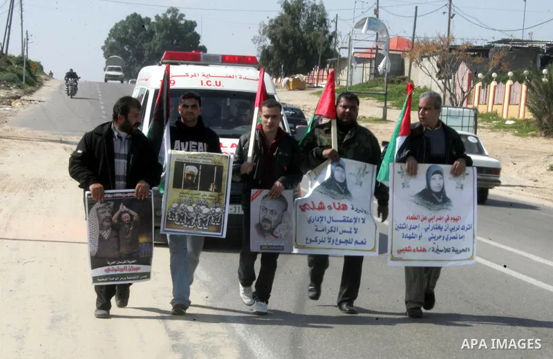 Palestinian Protestors hold a picture of Palestinian prisoner Hana'a Shalabi, in Rafah City, southern Gaza Strip, on Mar. 05, 2012. Photo by Abed Rahim Khatib