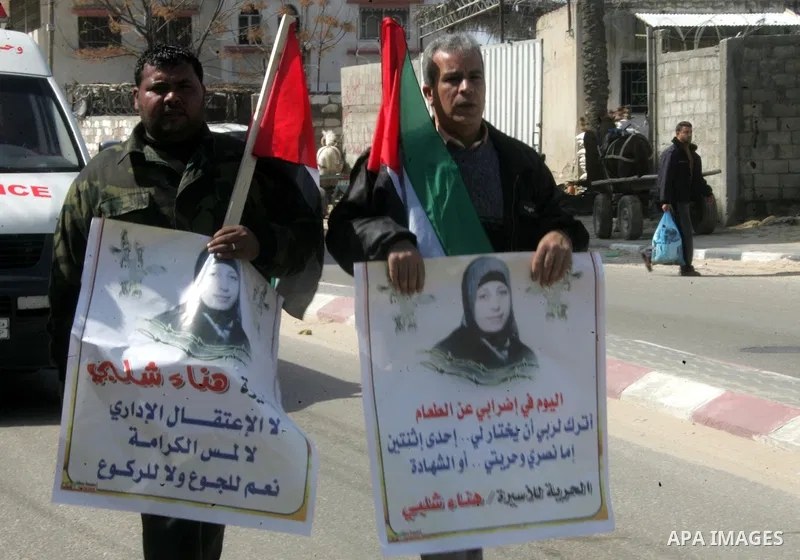 Palestinian Protestors hold a picture of Palestinian prisoner Hana'a Shalabi, in Rafah City, southern Gaza Strip, on Mar. 05, 2012. Photo by Abed Rahim Khatib