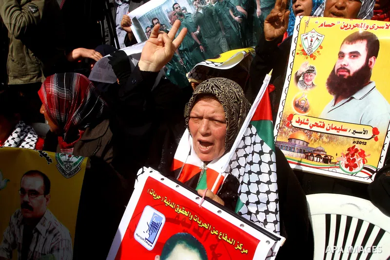 Palestinians demonstrate in solidarity with Hana'a Shalabi during a protest in Gaza City, on mar. 05, 2012. Shalabi, released by Israel in a prisoner swap last year but re-arrested earlier this month and held without cha...