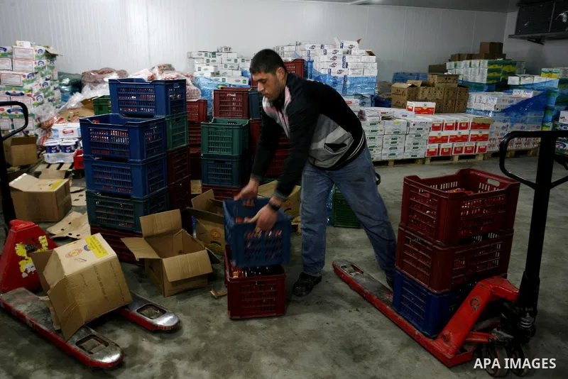 Palestinian workers employed in the warehouses of refrigerators for goods in Nusseirat refugee camp in central Gaza Strip on March 5, 2012. While the owners of freezers traders suffer from power cuts and lack of diesel f...