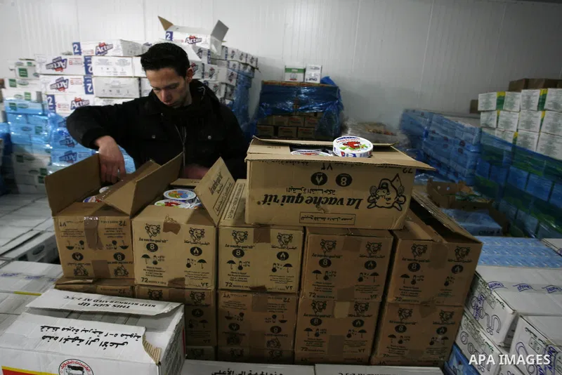 Palestinian workers employed in the warehouses of refrigerators for goods in Nusseirat refugee camp in central Gaza Strip on March 5, 2012. While the owners of freezers traders suffer from power cuts and lack of diesel f...