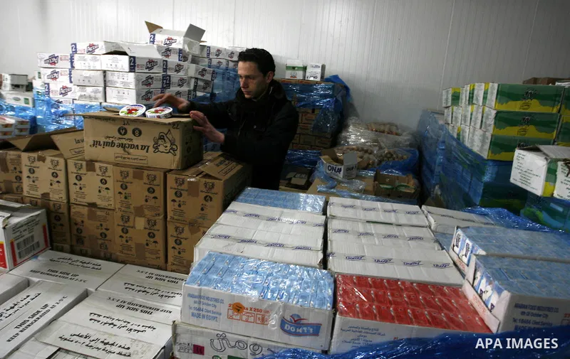 Palestinian workers employed in the warehouses of refrigerators for goods in Nusseirat refugee camp in central Gaza Strip on March 5, 2012. While the owners of freezers traders suffer from power cuts and lack of diesel f...