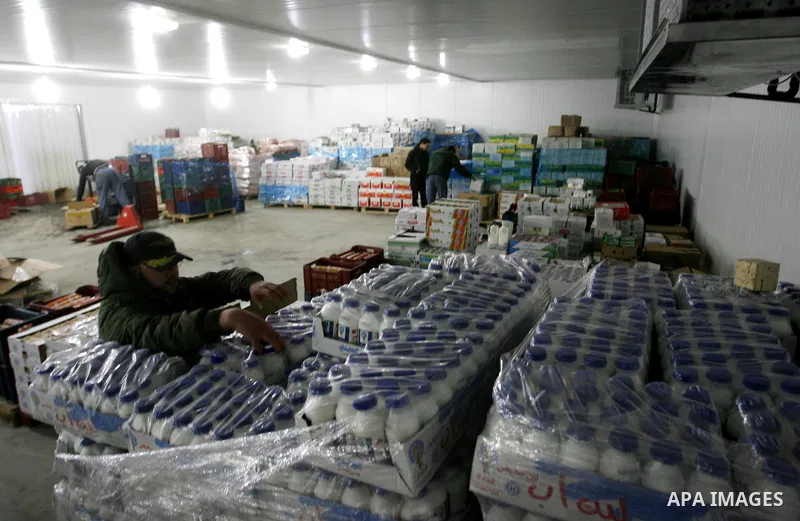 Palestinian workers employed in the warehouses of refrigerators for goods in Nusseirat refugee camp in central Gaza Strip on March 5, 2012. While the owners of freezers traders suffer from power cuts and lack of diesel f...