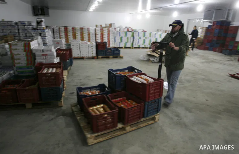 Palestinian workers employed in the warehouses of refrigerators for goods in Nusseirat refugee camp in central Gaza Strip on March 5, 2012. While the owners of freezers traders suffer from power cuts and lack of diesel f...