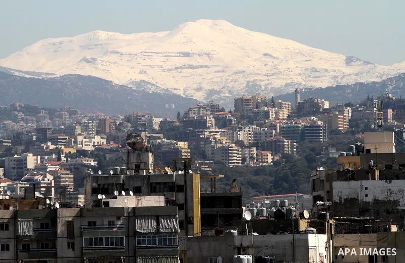 Snow covers Beirut mountains (background) in Lebanon, after a heavy snowstorm, March 5, 2012. Photo by Mohammed Asad