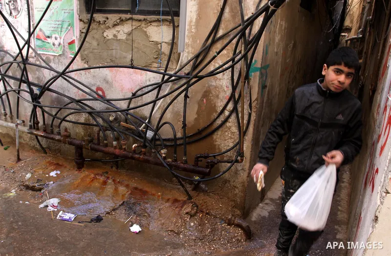 Palestinians walk in alley in one of the most poor regions at Burj al-Barajneh Palestinian refugee camp in Beirut, in Lebanon, March 5, 2012. About 25,000 person live in this poor refugee camp who face hard and difficult...