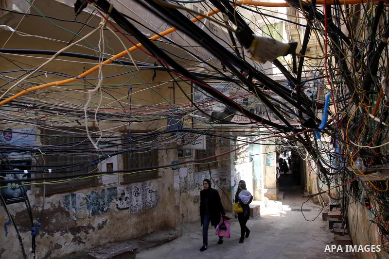 Palestinians walk in alley in one of the most poor regions at Burj al-Barajneh Palestinian refugee camp in Beirut, in Lebanon, March 5, 2012. About 25,000 person live in this poor refugee camp who face hard and difficult...