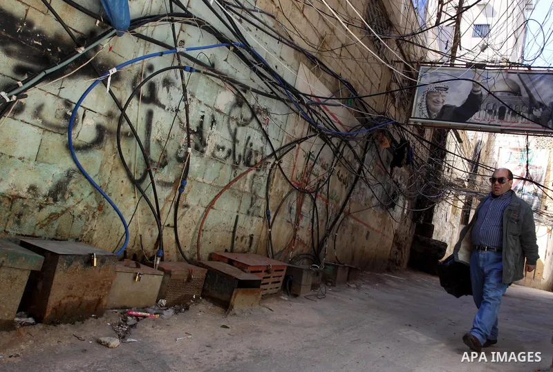 Palestinians walk in alley in one of the most poor regions at Burj al-Barajneh Palestinian refugee camp in Beirut, in Lebanon, March 5, 2012. About 25,000 person live in this poor refugee camp who face hard and difficult...
