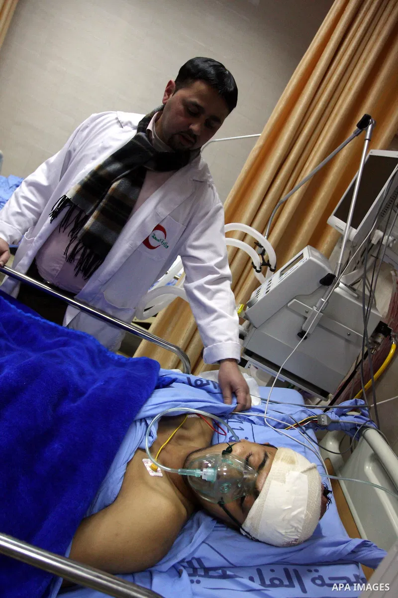 Palestinian Mohammed Abu-Awad, 19, injured by Israeli soldiers at a checkpoint near Ramallah earlier, receives treatment in hospital in the West Bank city of Ramallah, Monday, March 5, 2012. A young Palestinian man throw...