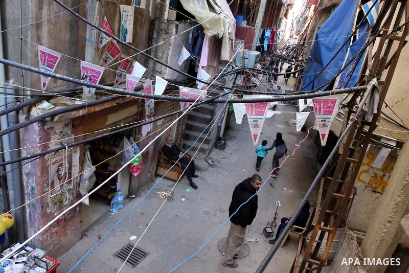 Palestinians walk in alley in one of the most poor regions at Sabra and Shatila Palestinian refugee camp in Beirut, in Lebanon, March 5, 2012. About 11,000 person live in this poor refugee camp who face hard and difficul...
