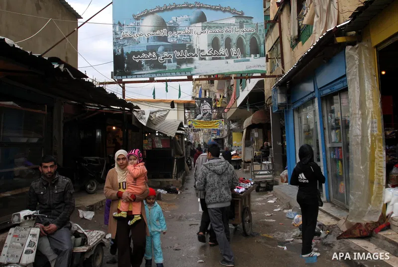 Palestinians walk in alley in one of the most poor regions at Sabra and Shatila Palestinian refugee camp in Beirut, in Lebanon, March 5, 2012. About 11,000 person live in this poor refugee camp who face hard and difficul...