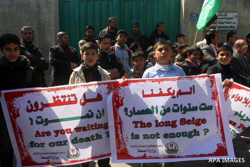 A Palestinian students take part in a protest in front of Egyptian Embassy in Gaza, calling for supplying the Gaza Strip with enough fuel on Mar. 06, 2012. Photo by Ashraf Amra