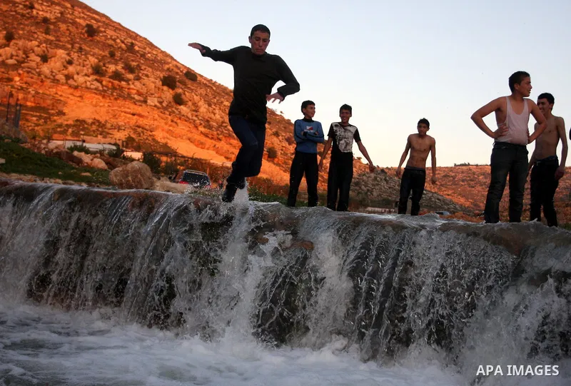 Palestinian children Swimming in the waters of "Wadi Ain Qeigna" in West Bank near Ramallah City, 6 March 2012. Photo by Issam Rimawi