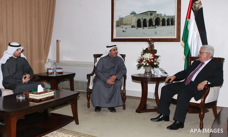 Palestinian President Mahmoud Abbas, meet with with the researcher Talal Zaid Al-Marzouq, in the West Bank city of Ramallah, on March 06, 2012. Photo by Thaer Ganaim