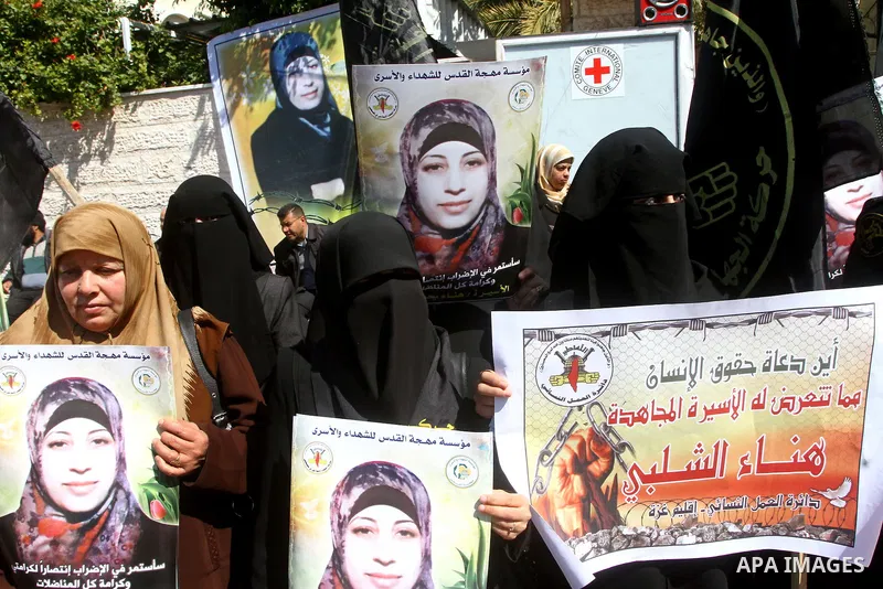 Palestinian women demonstrate in solidarity with Hana'a Shalabi during a protest in front of red cross in Gaza City, on mar. 07, 2012. Shalabi, released by Israel in a prisoner swap last year but re-arrested earlier this...