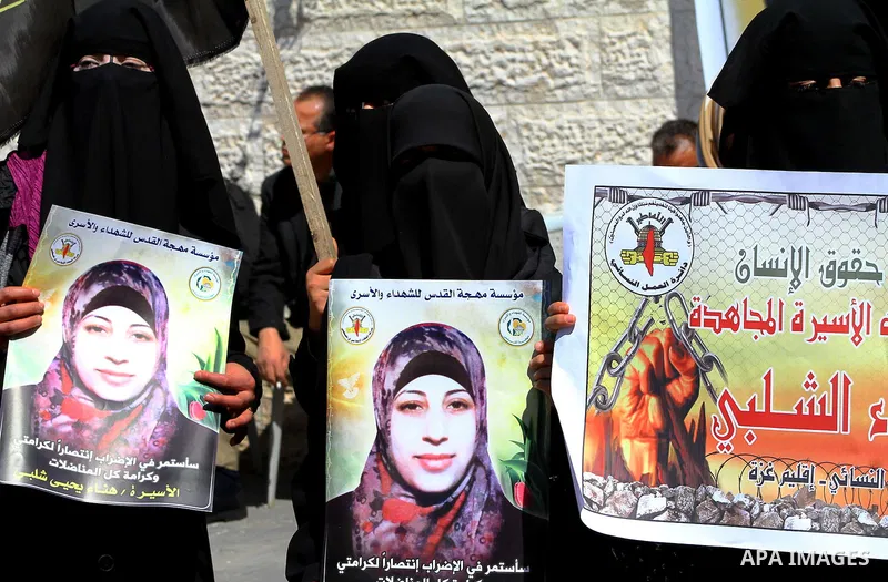 Palestinian women demonstrate in solidarity with Hana'a Shalabi during a protest in front of red cross in Gaza City, on mar. 07, 2012. Shalabi, released by Israel in a prisoner swap last year but re-arrested earlier this...