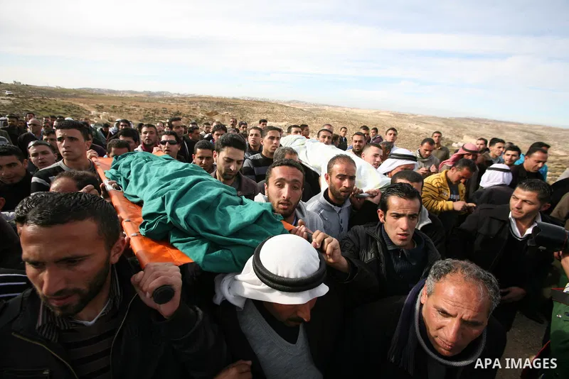 Palestinian mourners carry the bodies of two boys who were killed the previous day when unexploded military ordinance detonated outside Hebron, during their funeral in Wadi al-Rim, West Bank, 07 March 2012. Palestinian p...