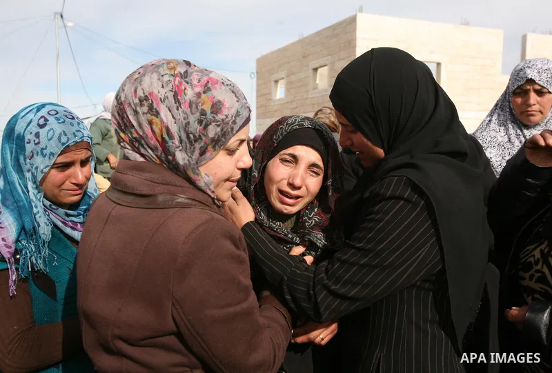 Palestinian women mourn during the funeral of two boys who were killed the previous day when unexploded military ordinance detonated outside Hebron, during their funeral in Wadi al-Rim, West Bank, 07 March 2012. Palestin...