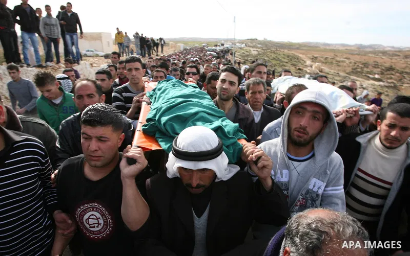Palestinian mourners carry the bodies of two boys who were killed the previous day when unexploded military ordinance detonated outside Hebron, during their funeral in Wadi al-Rim, West Bank, 07 March 2012. Palestinian p...