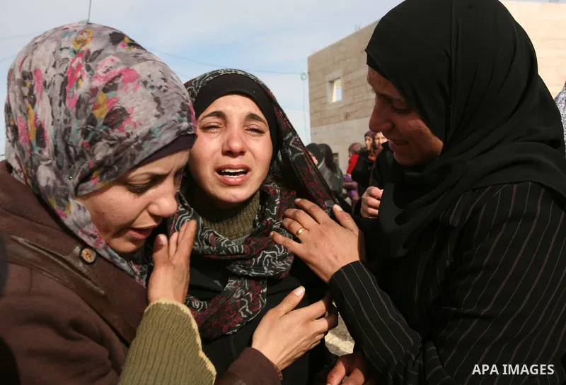 Palestinian women mourn during the funeral of two boys who were killed the previous day when unexploded military ordinance detonated outside Hebron, during their funeral in Wadi al-Rim, West Bank, 07 March 2012. Palestin...