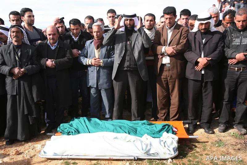 Palestinian mourners pray next to the bodies of two boys who were killed the previous day when unexploded military ordinance detonated outside Hebron, during their funeral in Wadi al-Rim, West Bank, 07 March 2012. Palest...