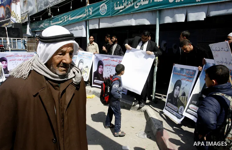 Palestinians demonstrate in solidarity with Hana'a Shalabi during a protest in Rafah, southern Gaza Strip on March 7, 2012. Shalabi, released by Israel in a prisoner swap last year but re-arrested earlier this month and...