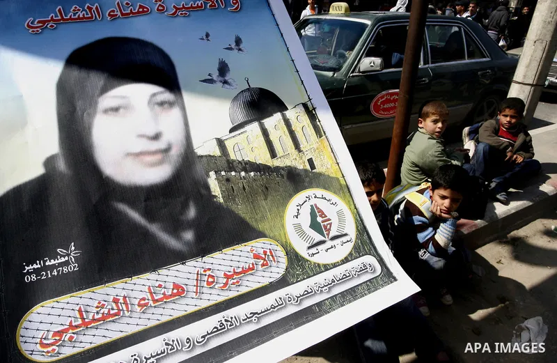 Palestinians demonstrate in solidarity with Hana'a Shalabi during a protest in Rafah, southern Gaza Strip on March 7, 2012. Shalabi, released by Israel in a prisoner swap last year but re-arrested earlier this month and...