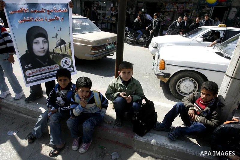 Palestinians demonstrate in solidarity with Hana'a Shalabi during a protest in Rafah, southern Gaza Strip on March 7, 2012. Shalabi, released by Israel in a prisoner swap last year but re-arrested earlier this month and...