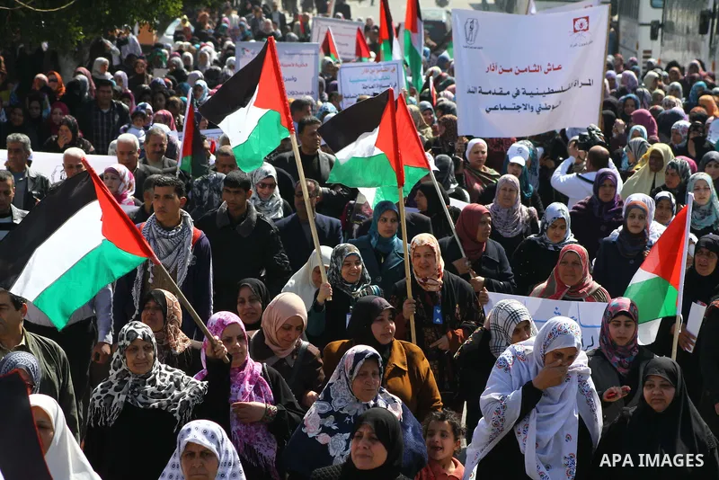 A Palestinian woman hold a poster during a protest calling for the release of Hana Shalabi, a female Palestinian prisoner jailed in Israel who has been on hunger strike for 22 days, outside the Red Cross building in Gaza...