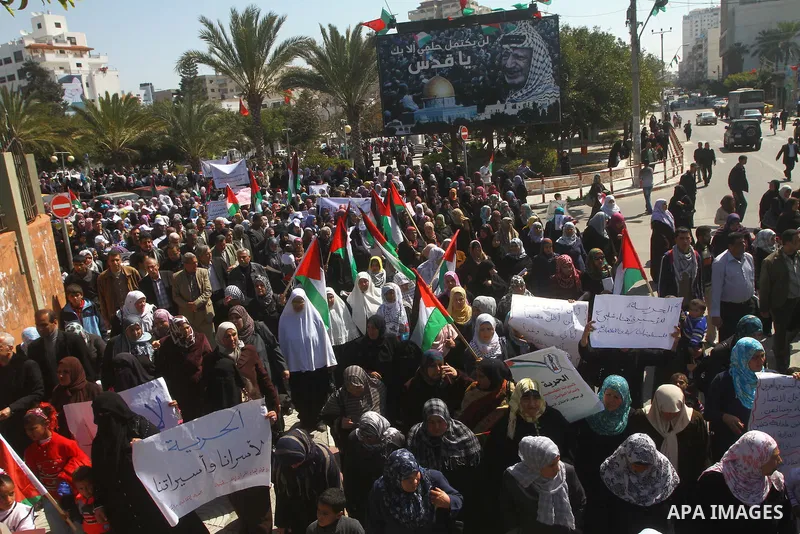 A Palestinian woman hold a poster during a protest calling for the release of Hana Shalabi, a female Palestinian prisoner jailed in Israel who has been on hunger strike for 22 days, outside the Red Cross building in Gaza...