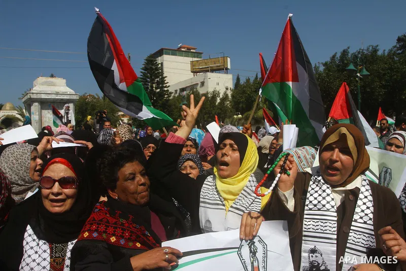 A Palestinian woman hold a poster during a protest calling for the release of Hana Shalabi, a female Palestinian prisoner jailed in Israel who has been on hunger strike for 22 days, outside the Red Cross building in Gaza...