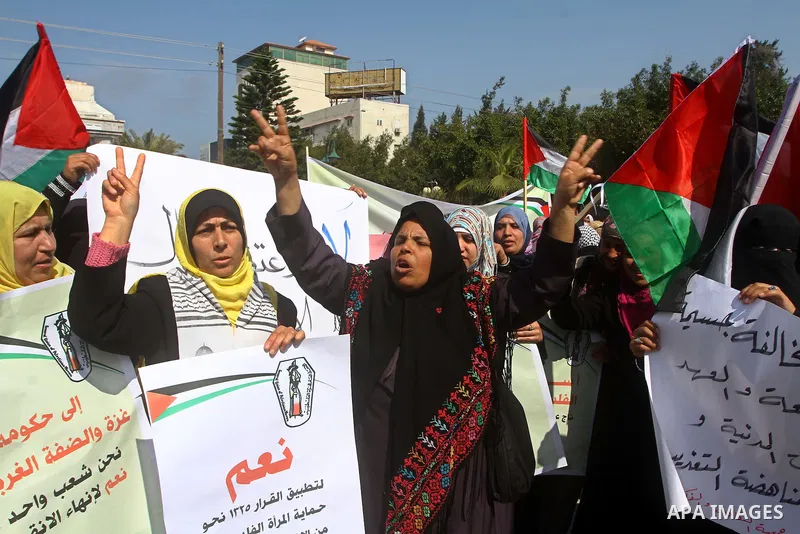 A Palestinian woman hold a poster during a protest calling for the release of Hana Shalabi, a female Palestinian prisoner jailed in Israel who has been on hunger strike for 22 days, outside the Red Cross building in Gaza...