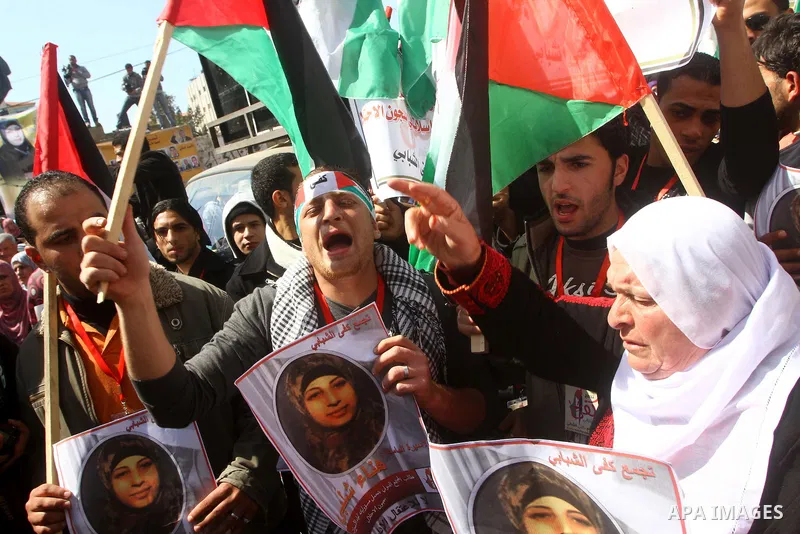 A Palestinian woman hold a poster during a protest calling for the release of Hana Shalabi, a female Palestinian prisoner jailed in Israel who has been on hunger strike for 22 days, outside the Red Cross building in Gaza...