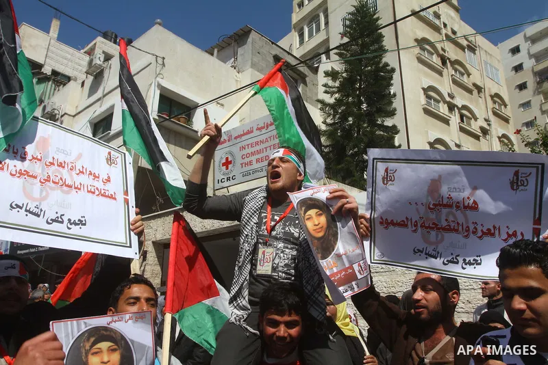 A Palestinian woman hold a poster during a protest calling for the release of Hana Shalabi, a female Palestinian prisoner jailed in Israel who has been on hunger strike for 22 days, outside the Red Cross building in Gaza...