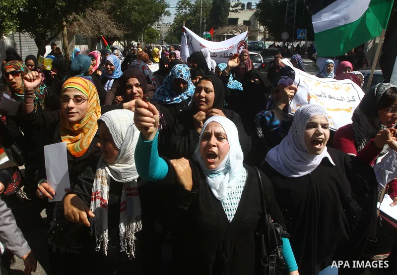 A Palestinian woman hold a poster during a protest calling for the release of Hana Shalabi, a female Palestinian prisoner jailed in Israel who has been on hunger strike for 22 days, outside the Red Cross building in Gaza...