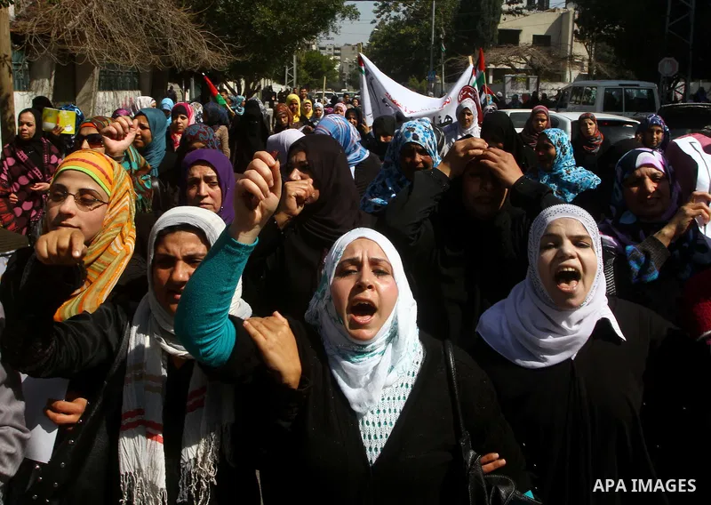 A Palestinian woman hold a poster during a protest calling for the release of Hana Shalabi, a female Palestinian prisoner jailed in Israel who has been on hunger strike for 22 days, outside the Red Cross building in Gaza...