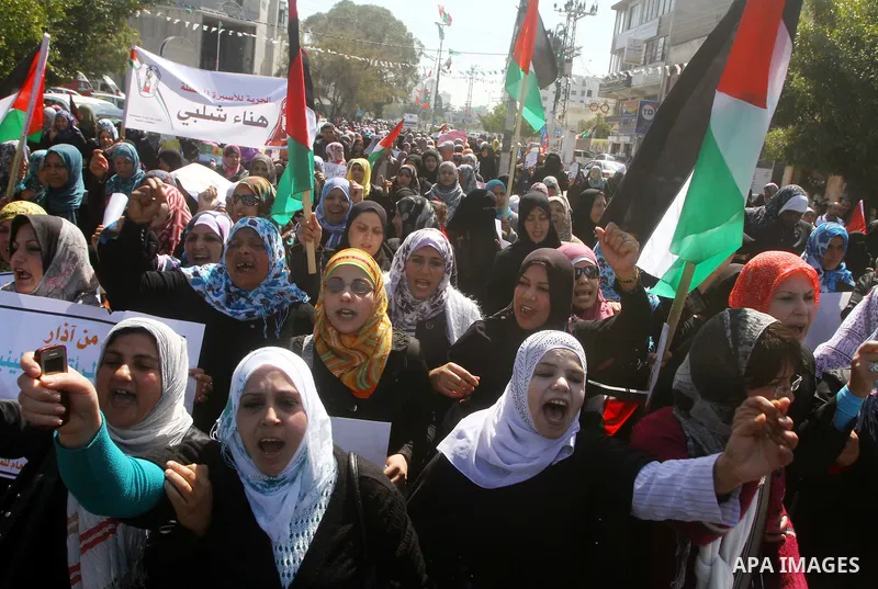 A Palestinian woman hold a poster during a protest calling for the release of Hana Shalabi, a female Palestinian prisoner jailed in Israel who has been on hunger strike for 22 days, outside the Red Cross building in Gaza...