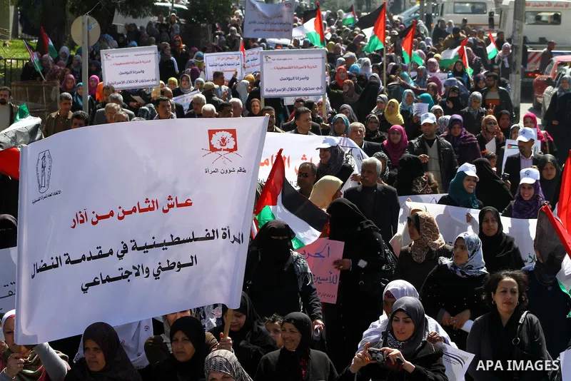A Palestinian woman hold a poster during a protest calling for the release of Hana Shalabi, a female Palestinian prisoner jailed in Israel who has been on hunger strike for 22 days, outside the Red Cross building in Gaza...