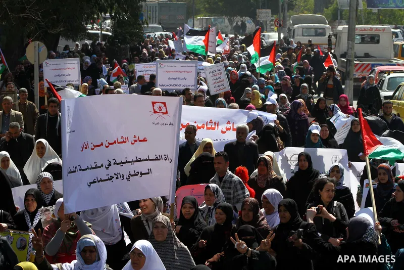 A Palestinian woman hold a poster during a protest calling for the release of Hana Shalabi, a female Palestinian prisoner jailed in Israel who has been on hunger strike for 22 days, outside the Red Cross building in Gaza...