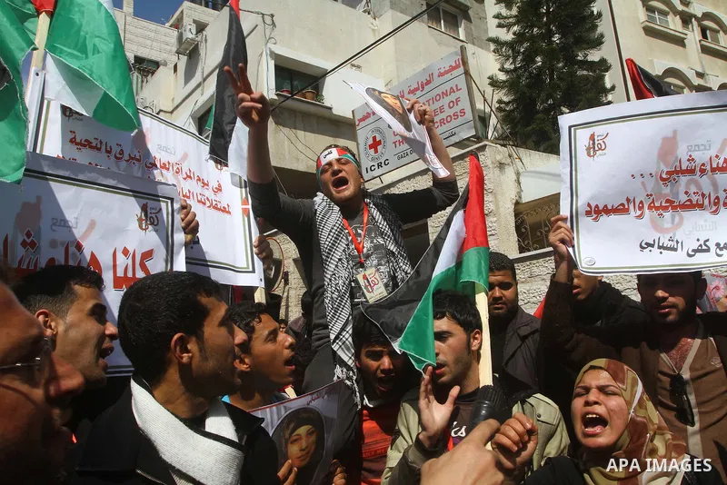 A Palestinian woman hold a poster during a protest calling for the release of Hana Shalabi, a female Palestinian prisoner jailed in Israel who has been on hunger strike for 22 days, outside the Red Cross building in Gaza...