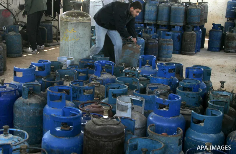 Palestinians wait to fill gas cylinders at a gas filling station in Khan Younis in the southern Gaza Strip March 8, 2012. Photo by Abed Rahim Khatib