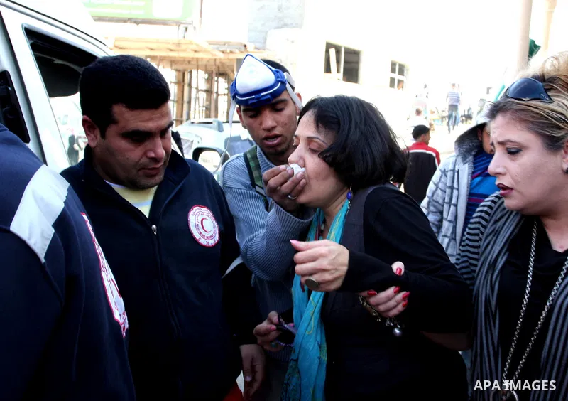 A Palestinian woman is being helped next to the checkpoint of Kalandia, West Bank, 08 March 2012, North of Jerusalem, victim of the clashes between protesters and Israely soldiers during a rally to mark the International...