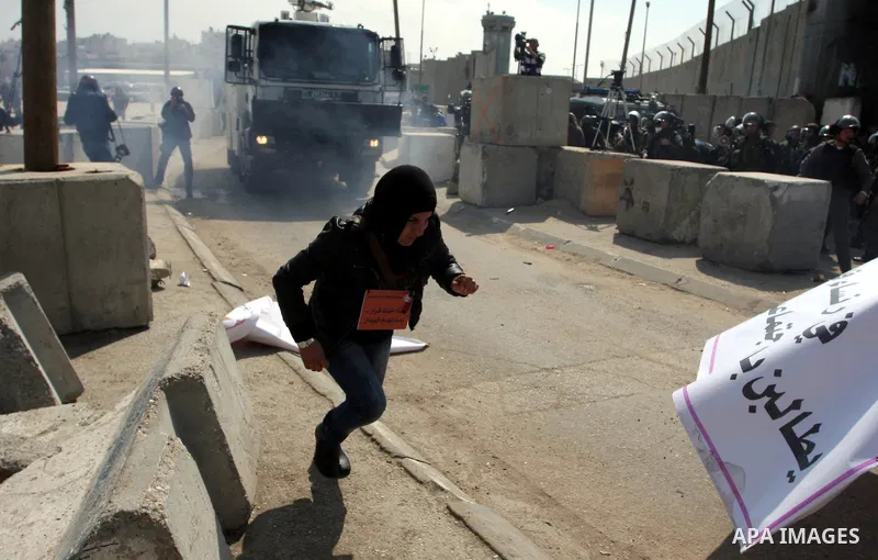 Palestinian women take part in a rally to mark International Women's Day and to show their solidarity with female Palestinian detainee Hana Shalabi, who is on hunger strike, at Qalandia checkpoint near the West Bank city...